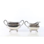 George V sterling silver sugar and cream, with serpent head handles and paw supports, Harrison