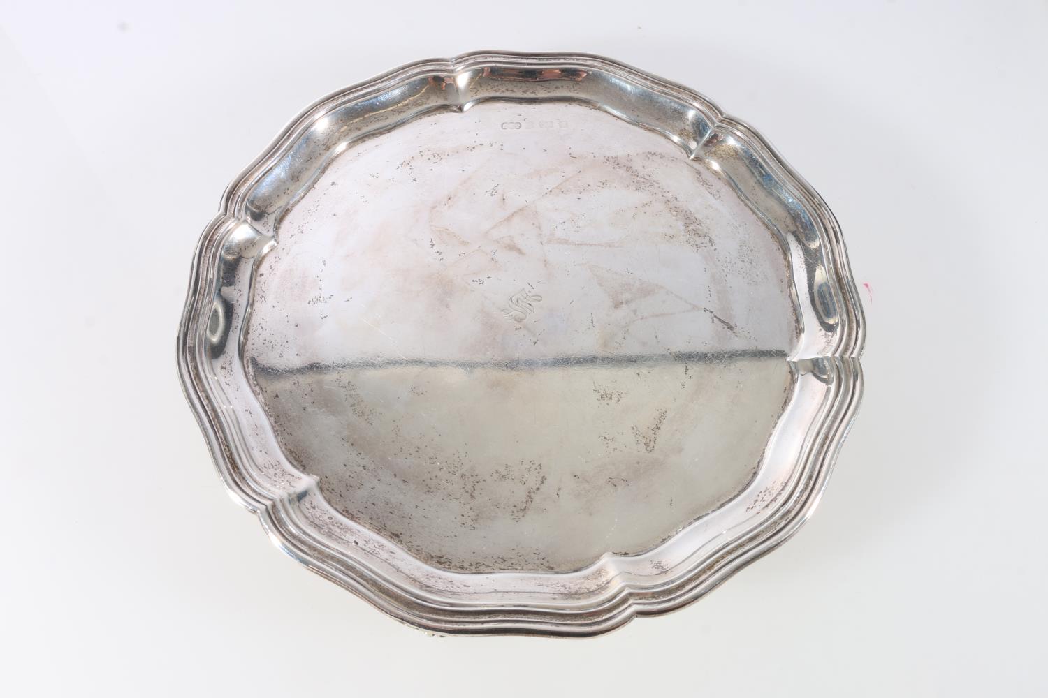 Sterling silver salver on tripod supports, with wavy edged rim, marks badly rubbed, Elkington & Co.,