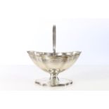 Edwardian sterling silver swing-handled sugar basket with crest to base, Garrard & Co., London 1907,