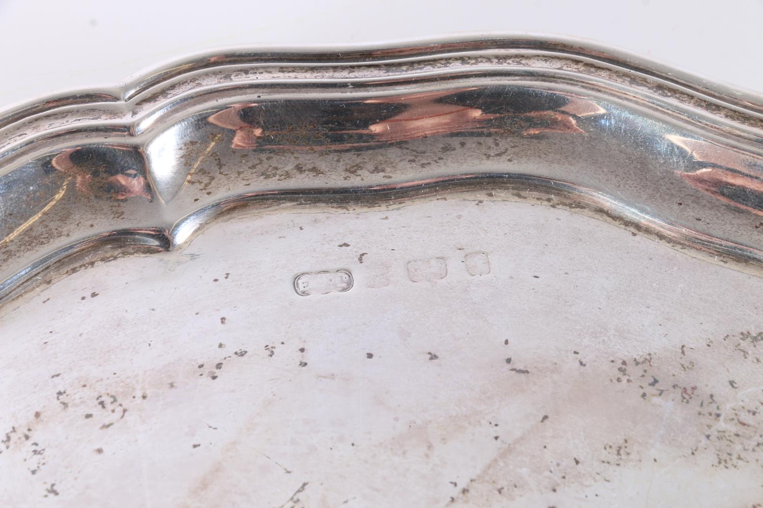 Sterling silver salver on tripod supports, with wavy edged rim, marks badly rubbed, Elkington & Co., - Image 2 of 3