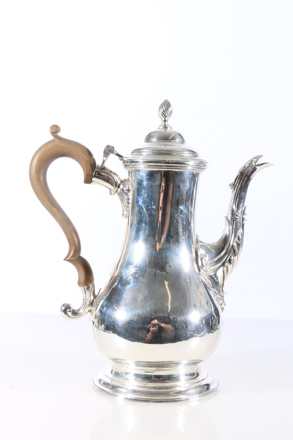 Early George III sterling silver coffee pot of pear shape, with finial topped hinged cover and