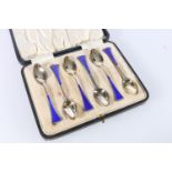 Cased set of six sterling silver teaspoons, with blue enamel terminals, Len & Salaman, Birmingham,