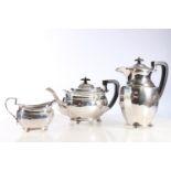 Sterling silver three piece tea service with shaped body and ball feet, Atkin Brothers, Sheffield,
