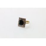 18ct gold diamond ring set with central baguette cut stone, London, size O, 7.6g.