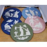 Five Wedgwood Jasper ware circular calendar wall plaques with classical decoration, in blue, spinach