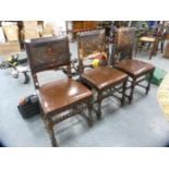 Set of three leather-upholstered dining chairs with embossed backs.