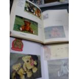 Three photograph albums of teddy bears.