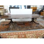 Reproduction Regency-style twin-pillar dining table with two additional leaves, retailed by