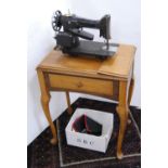 Singer table sewing machine, no. 41671, instruction booklet and some accessories.