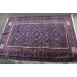 Turkish-style hand-knotted rug on red and blue ground, 191cm x 130cm.