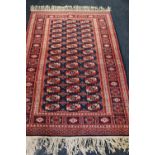 Bokhara rug on a red and blue ground, 190cm x 125cm.