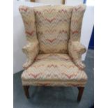 Early 20th century upholstered wing armchair (a/f).