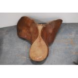 Brown leather trefoil-shaped saddle.