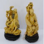 Two similar oriental painted resin figure groups, one modelled as an Immortal with staff, the