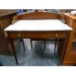 Edwardian mahogany wash stand with three-quarter gallery and marble top.