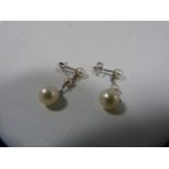 Pair of drop earrings, each with three pearls in sizes, in 9ct white gold.