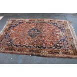 Belouch hand-knotted rug on red and blue ground, 240cm x 164cm.