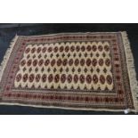 Bokhara rug on cream ground, 183cm x 123cm.