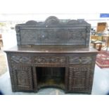 Jacobean Revival carved oak sideboard with pediment back.