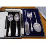 Set of three EP serve-alls and a pair of EP serving spoons, cased.