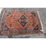 Belouch hand-knotted rug on rust ground, 162cm x 114cm.