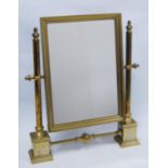 Brass-framed toilet mirror.