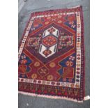 Persian hand-knotted rug on a red and cream ground, 206cm x 136cm.