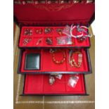 Jewellery box containing miscellaneous costume jewellery to include amber-coloured bracelets,