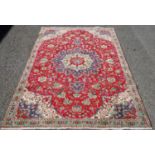 Persian Tabriz rug decorated with a floral medallion to the centre within foliate and geometric