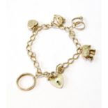 9ct gold curb bracelet with various charms, 16.4g.