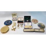 Gold pin with clear gem, four compacts, four watches and other items.