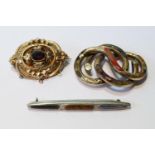 Victorian gold and garnet brooch, another with 'Scotch pebbles', and a similar silver brooch.