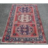 North west Persian hand-knotted rug decorated with three floral and geometric octagonal medallions