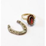 Garnet navette cluster ring in 9ct gold, size N, and a silver horseshoe charm, 1932.  (2)