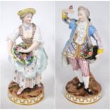 Near pair of Meissen-style continental porcelain figures modelled as a couple holding baskets of