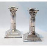 Pair of silver dwarf candlesticks with Corinthian capitals, Walker & Hall, Sheffield 1902, 15cm.