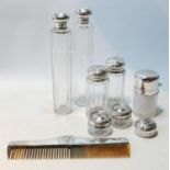 Various mounted silver-topped glass toilet water bottles and other items.