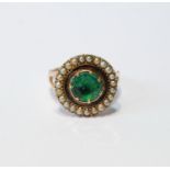 Unusual Victorian ring with foiled emerald, 8mm, in a circle of pearls, 15mm, in gold, '9ct', size