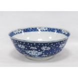 Chinese Kangxi-style bowl with all over white prunus decoration on a blue ground, four character