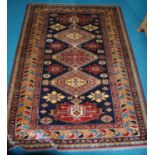 Qashqai rug decorated with five geometric medallions on a blue ground with a red and cream border,