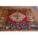 Old Turkish Konya rug decorated with a central floral medallion and geometric and floral motifs to