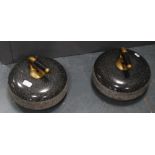 Pair of curling stones, each with a brass and wood grip.  (2)