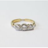 Diamond three-stone ring, the brilliants approximately .5ct and .25ct, adjustable, sizes L to P,