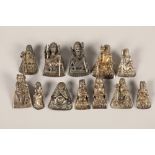 Twelve white metal Chinese gods