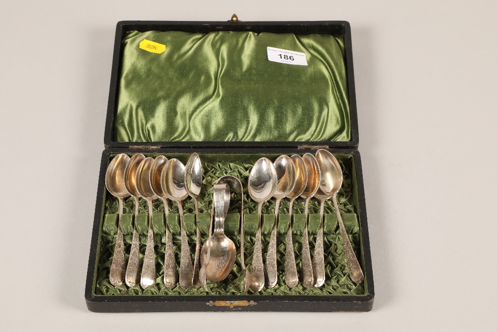 A cased set of twelve hallmarked Silver tea spoons and matching sugar tongs with a silver caddy