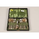 A cased set of twelve hallmarked Silver tea spoons and matching sugar tongs with a silver caddy