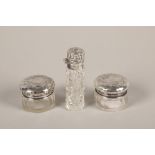 Three silver topped dressing table jars
