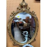 Oval gilt hanging wall mirror