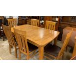 Oak extending dining room table with six matching chairs