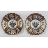 Pair of Japanese Imari chargers of circular lobed form with central panels of vases of flowers and